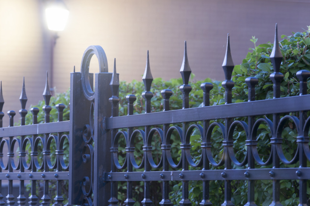 Metal fence with light under green