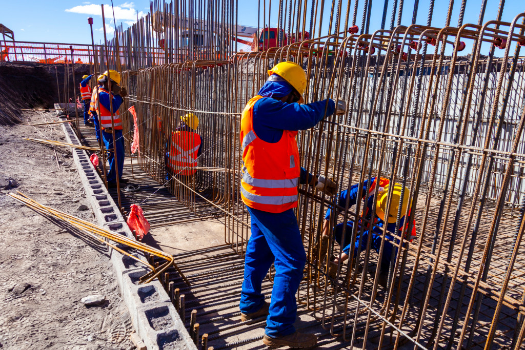 a construction team wearing protective gear while building a foundation