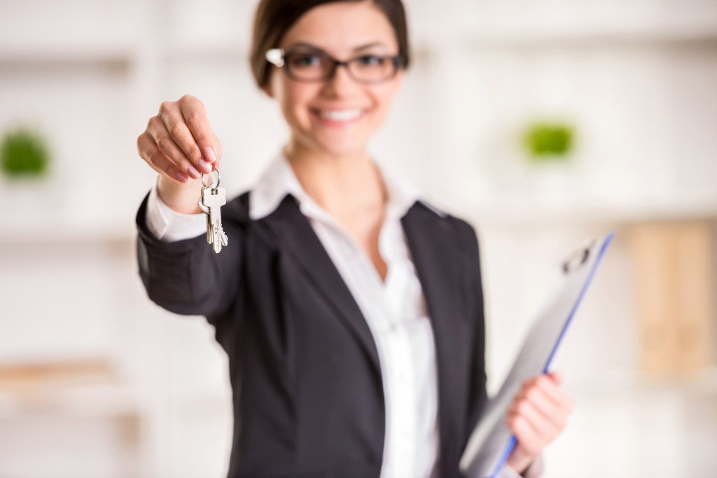 Female real estate agent holding a key