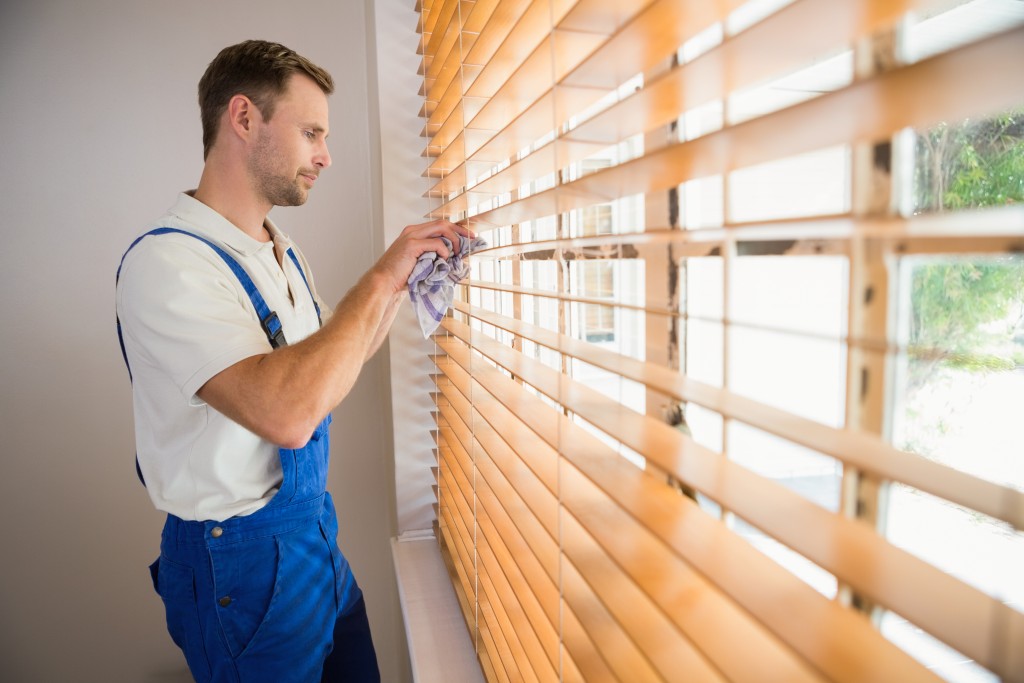 man standing close the window