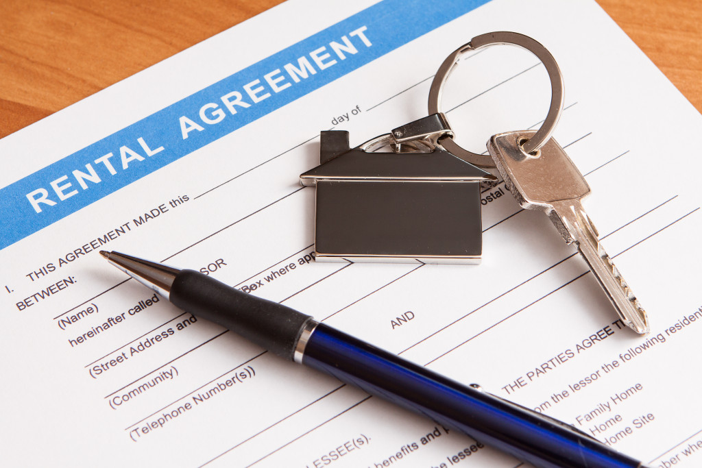 A rental agreement document with pen and key