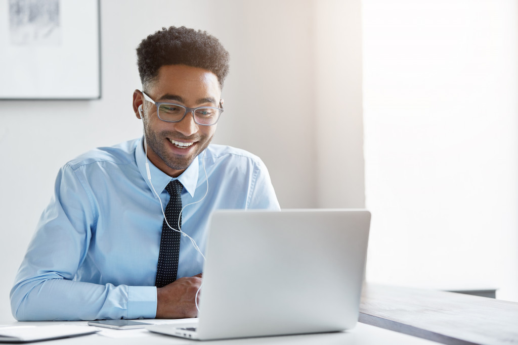 A man in office attire talking to someone through video call