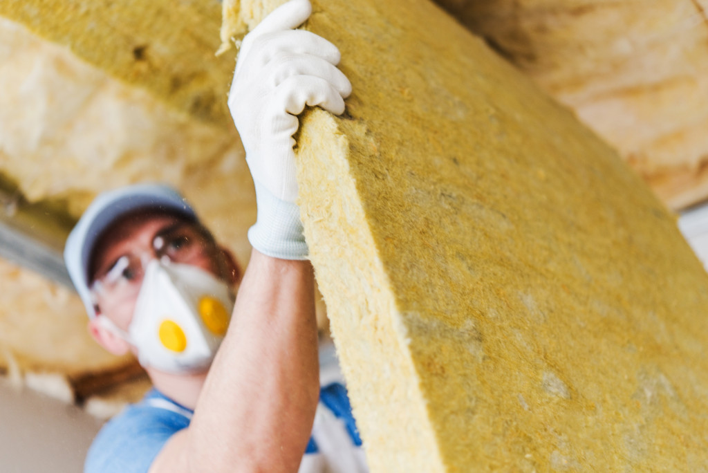 A worker adding insulation