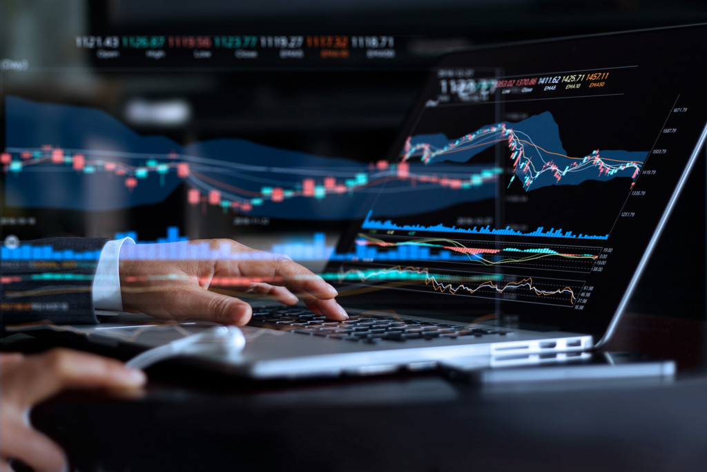 businessman doing market research in laptop